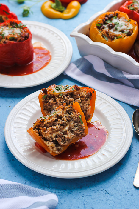 Colorful stuffed peppers filled with a savory rice, vegetables, and seasonings.